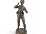 bronze statue of a man with a hat and tie on a white background