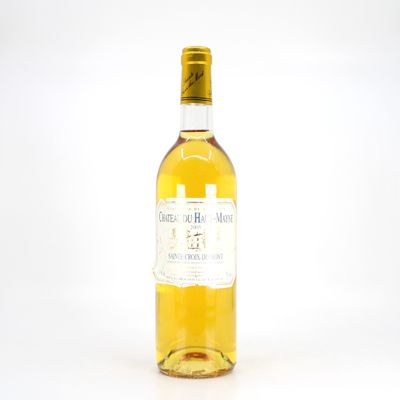 a bottle of white wine sitting on top of a white table