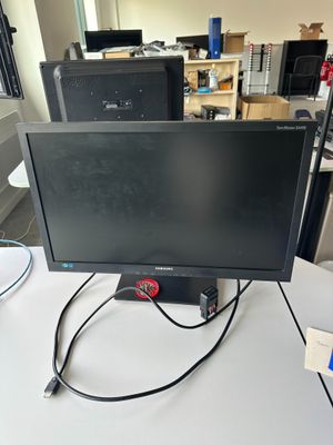 a computer monitor sitting on top of a white desk