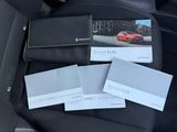 three business cards sitting on the back of a car