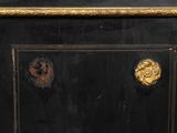 a close up of a black cabinet with gold decorations