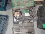 une boîte à outils posée par terre à côté d'autres outils