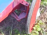 a red and blue toy car sitting on the grass