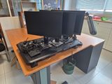 a desk with two computer monitors and a keyboard on it