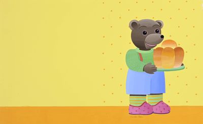 un ours de dessin animé tenant une miche de pain