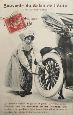 an old advertisement for a car with a woman working on it