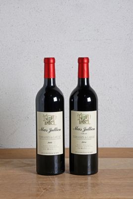 two bottles of wine sitting on a wooden table next to a bottle of wine