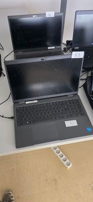 three laptops sitting on a table next to each other
