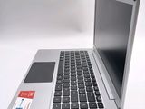 a silver laptop with a black keyboard on a white surface