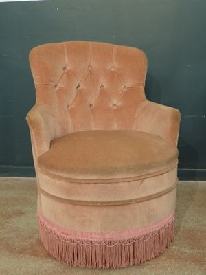 a pink chair with a pink fringe around it