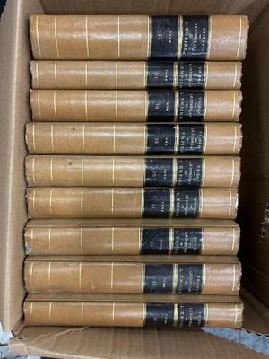 six books in a cardboard box on a table