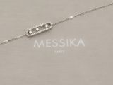a close up of a silver bracelet with a diamond bar on it