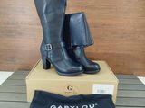a pair of black boots sitting on top of a box