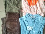 a lot of clothes that are sitting on the floor
