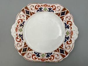 a white plate with a brown and blue design on it