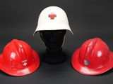 two red hard hats and a white hard hat on a black background