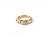 an image of a gold ring with a green stone