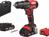 a cordless drill with two batteries and a tool case