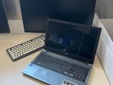 a laptop computer sitting on a desk next to a monitor and keyboard