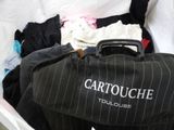 a black suitcase with clothes in it sitting on a bed