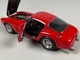 a red toy car with open doors on a white surface