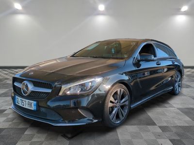 a black mercedes cla parked on a checkered floor
