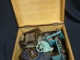 a wooden box with a toy gun inside of it