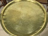 a gold tray sitting on top of a wooden table