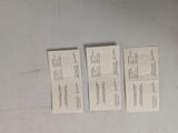 three small business cards sitting on top of a table next to a pair of scissors