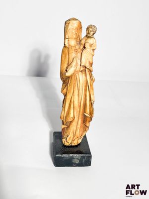 an image of a statue of a woman holding a child
