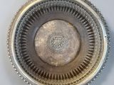 a silver plate with a design on it on a table