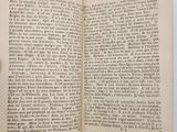an open book with a hand holding it in front of it