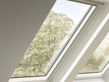 three windows in the roof of a room that have been painted white