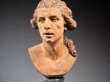 a close up of a bust of a man on a pedestal
