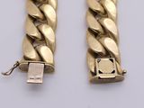 two gold bracelets with a usb drive attached to them