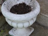 a white planter sitting on the steps outside of a house