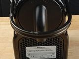 a close up of a coffee maker on a wooden table
