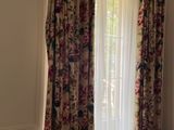 a bedroom with a bed and a window with curtains
