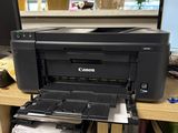 a printer sitting on top of a desk next to a computer