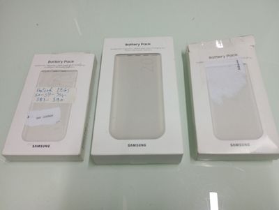 three boxes of samsung phones sitting on a table next to each other