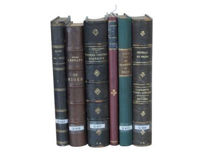 several books are stacked on top of each other on a white surface