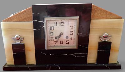 marble mantle clock with black and white marbles on a gray background
