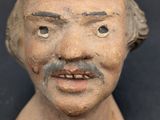 a close up of a clay head of a man
