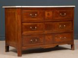 a wooden chest of drawers with a marble top