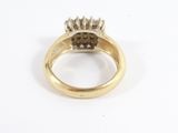 an image of a gold ring with a cluster of diamonds