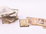 a pile of old photos on a table with a white background