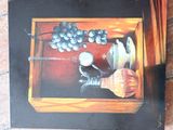 a picture of a painting of grapes in a wooden box
