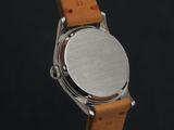 an image of a close up of a watch on a black background