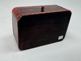 a small wooden box with a metal latch on it