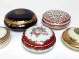 several different types of decorative boxes sitting on a white surface